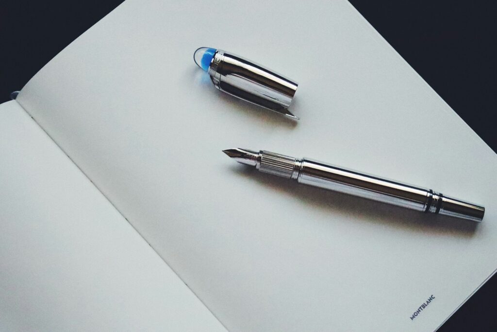 silver and blue click pen